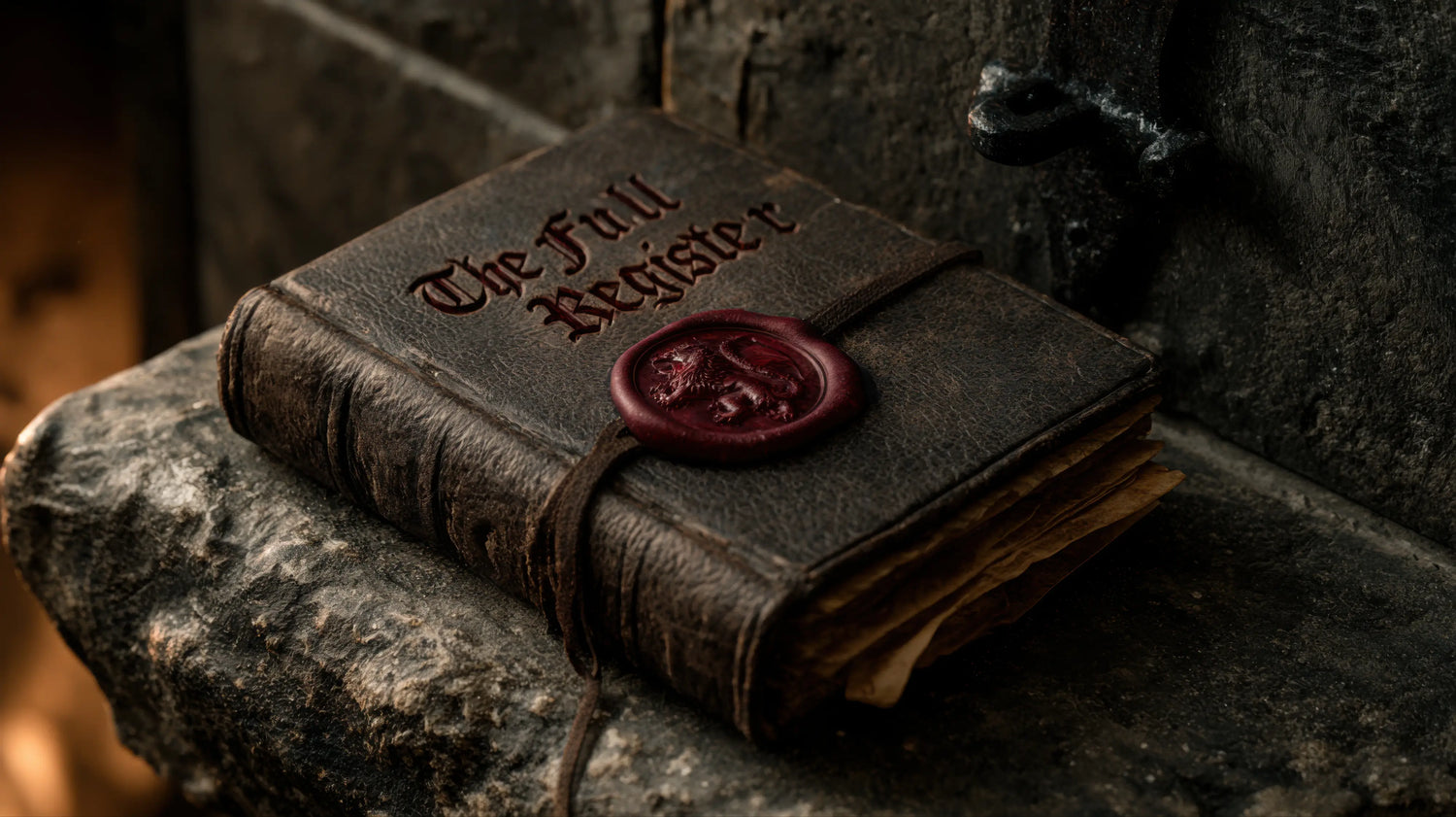 A moody, close-up photograph of a heavy, antique leather-bound book titled The Full Register resting on a rugged stone ledge inside the Caracoda Equestrian workshop. The weathered leather cover is secured by a leather strap and a prominent, dark red wax seal bearing a heraldic lion crest. The frayed, aged parchment pages and atmospheric lighting perfectly capture the rich history, hidden lore, and enduring English heritage behind our bespoke craftsmanship.